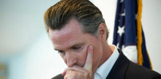 Man thinking with hand on chin flag background