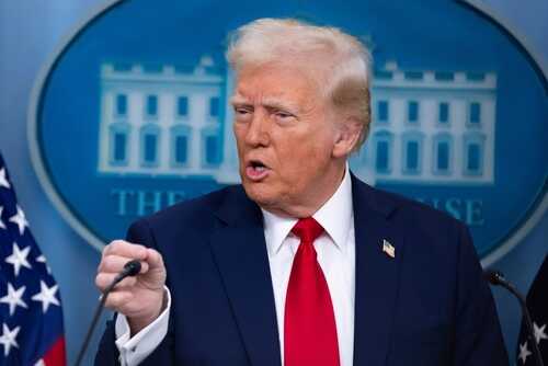 shutterstock_2591233541 (1).jpg A man in a suit speaking at a press conference with a serious expression