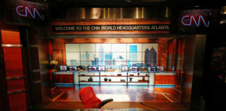 News studio with chair desk and city backdrop