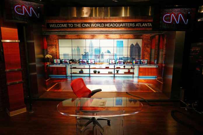 News studio with chair desk and city backdrop