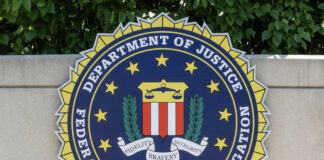 FBI seal on stone wall with foliage background