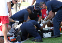 Baby Miracle: Flung 15 Feet, Survives! Emergency responders assisting person on grass lawn