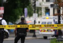 Intelligence FAILURE Enables Mass Beach Slaughter Police officers near a crime scene marked by caution tape