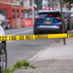 Dentist Couple MURDERED – Manhunt Underway Police tape blocking street with parked cars