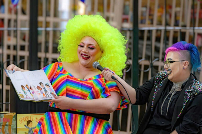 2164843967 Person reading childrens book with bright colorful outfit