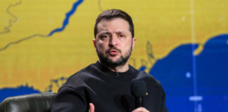 Man speaking into microphone with map background