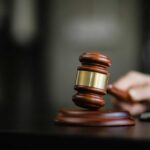 Policy Bombshell Inside Women’s Prisons Wooden gavel on a dark surface
