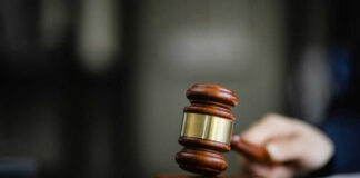 Wooden gavel on a dark surface